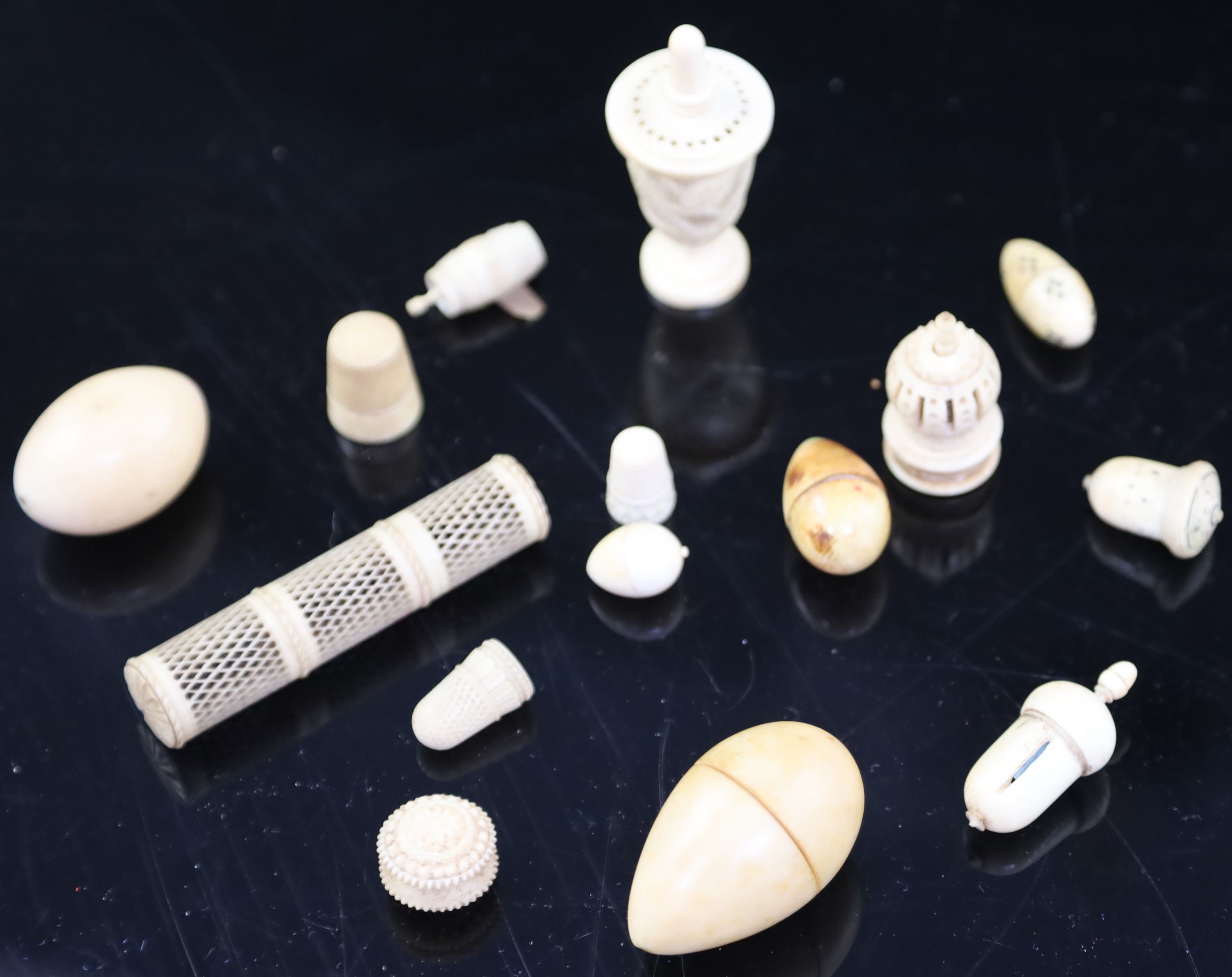 A collection of assorted early 19th century and later carved ivory sewing accessories